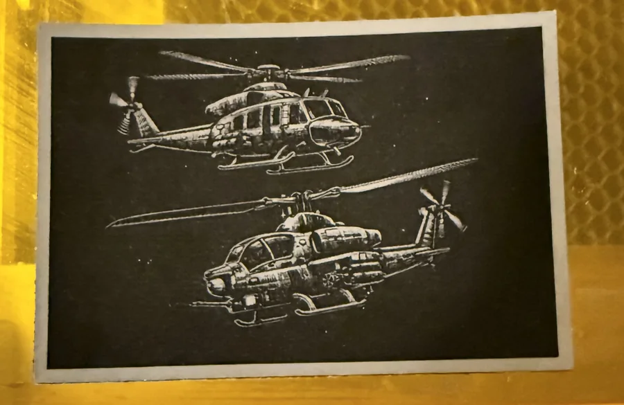 Detailed helicopter artwork engraved into a dark leather patch