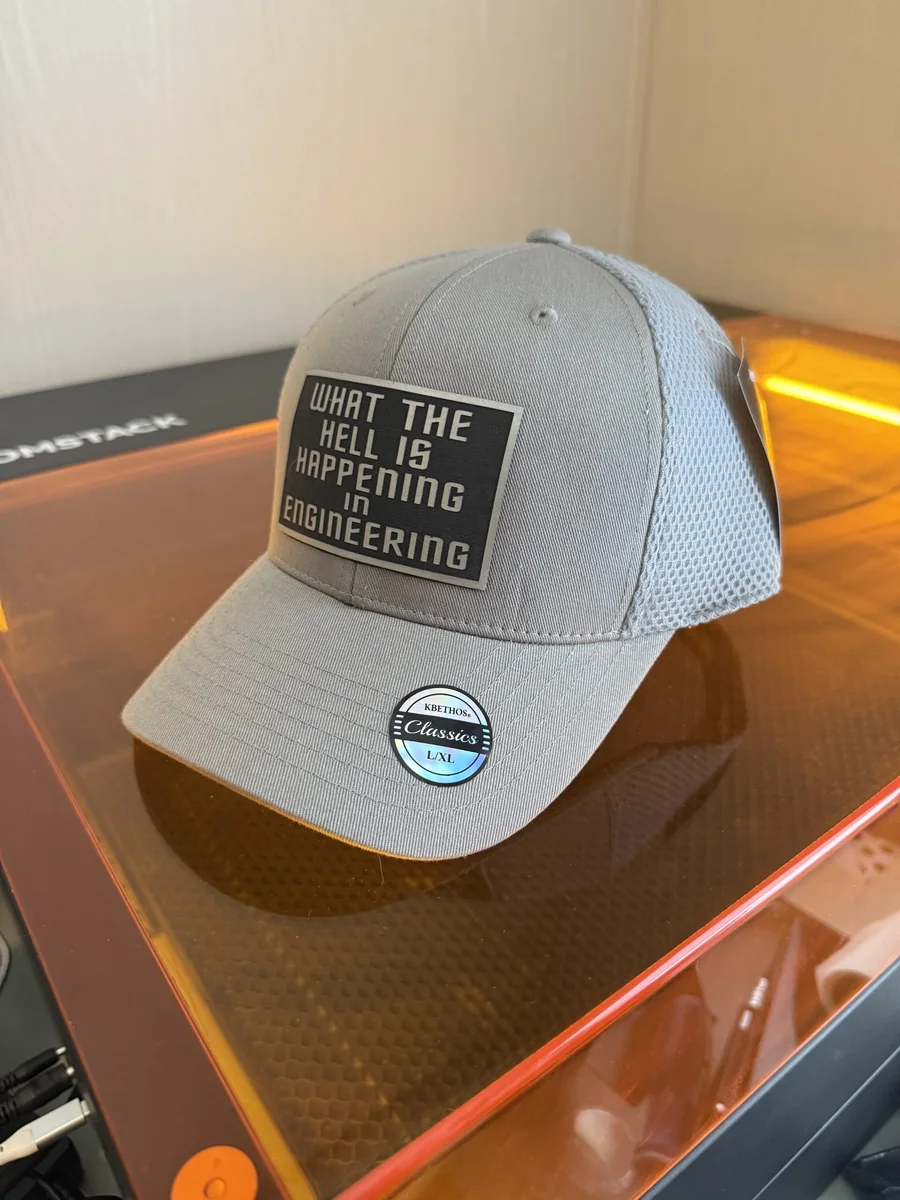 Gray cap with an engraved engineering humor patch