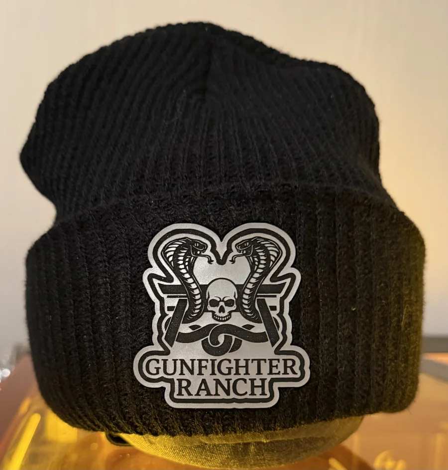 Black knit beanie with a custom engraved leatherette patch