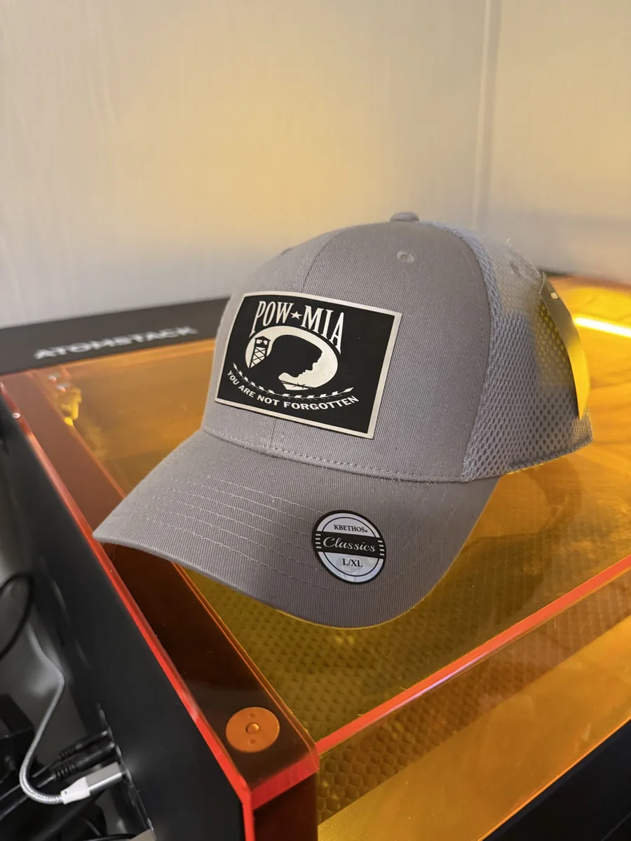 Gray cap with a black and white POW MIA tribute patch